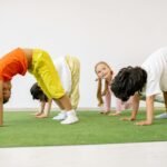 Happy children engaging in playful exercise and learning indoors, fostering group togetherness.