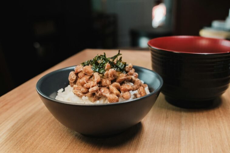 Close-up of a traditional Japanese breakfast bowl with natto and rice, capturing cultural essence.