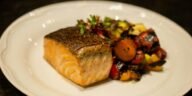 Delicious grilled salmon served with colorful roasted vegetables. Perfect for healthy dining.