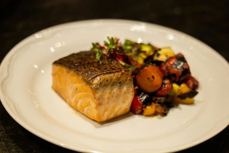 Delicious grilled salmon served with colorful roasted vegetables. Perfect for healthy dining.