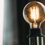 A glowing vintage light bulb adds a warm ambiance, ideal for home decor or office settings.