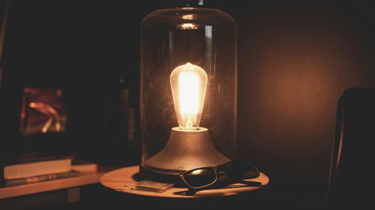 Warm glow of a vintage Edison bulb in a glass dome, creating a cozy ambiance.