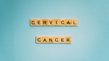 Scrabble tiles spelling 'Cervical Cancer' on a light blue background, symbolizing awareness.