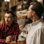 Two men enjoy refreshing draft beer in a cozy pub atmosphere.