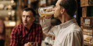 Two men enjoy refreshing draft beer in a cozy pub atmosphere.