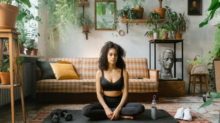Serene yoga session at home with plants creating a calming ambiance.
