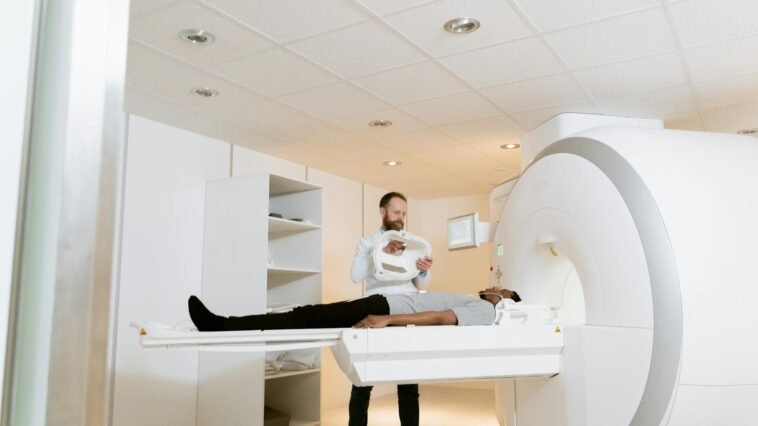 A doctor assists a patient during an MRI scan in a modern medical clinic.