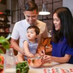 A joyful family bonding in the kitchen while preparing a meal together.
