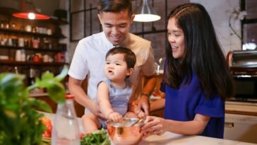 A joyful family bonding in the kitchen while preparing a meal together.