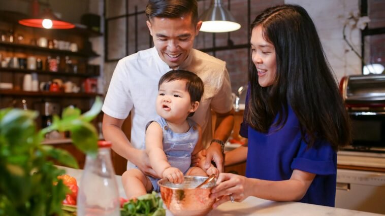 A joyful family bonding in the kitchen while preparing a meal together.