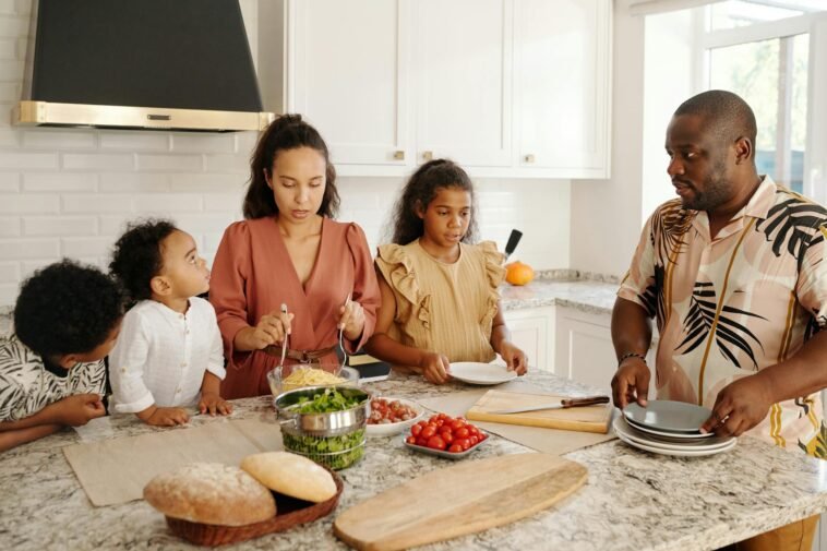 Family cooking together in a bright kitchen, enjoying quality time and preparing a delicious meal.