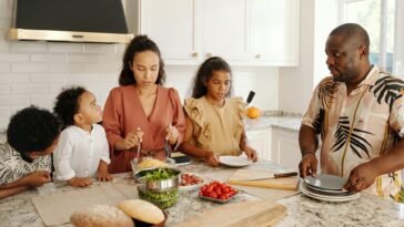 Family cooking together in a bright kitchen, enjoying quality time and preparing a delicious meal.
