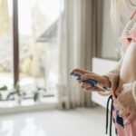 Focused woman administering insulin with pen in a home setting, emphasizing health care and diabetes management.