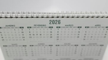 Close-up of a 2026 spiral-bound desk calendar with months in Portuguese.